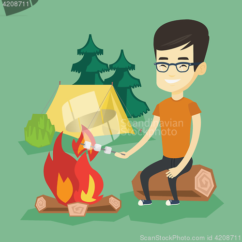 Image of Woman roasting marshmallow over campfire.