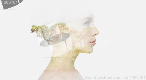 Image of beautiful young woman face over natural background