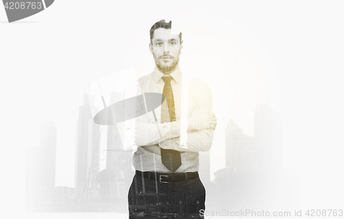 Image of businessman with crossed arms over city buildings