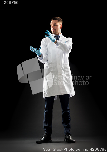 Image of doctor or scientist in lab coat and medical gloves