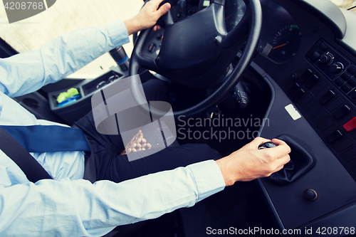 Image of close up of driver driving passenger bus