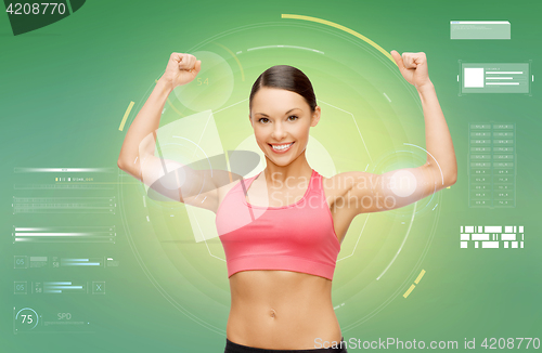 Image of happy sporty woman showing biceps