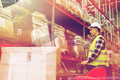 Image of man on forklift loading cargo at warehouse