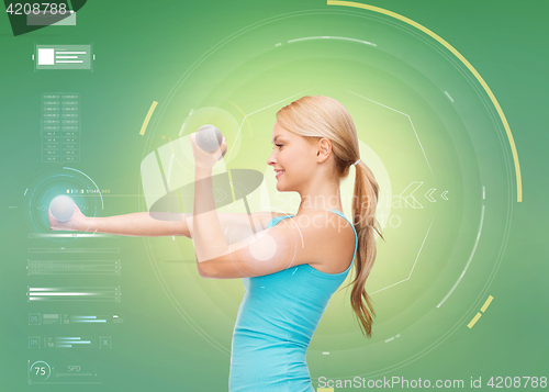 Image of happy sporty woman with dumbbells flexing biceps