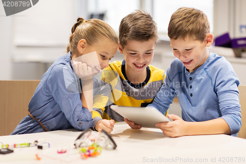 Image of kids with tablet pc programming at robotics school