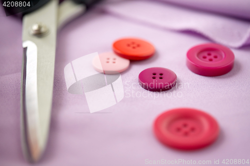 Image of scissors, sewing buttons and cloth