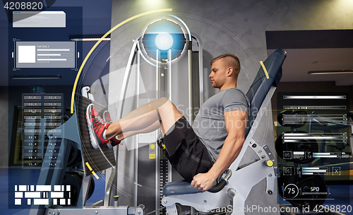 Image of man flexing leg muscles on gym machine