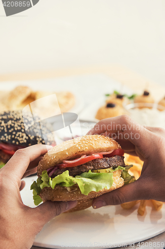 Image of Man eating burgers