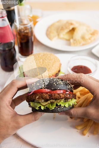 Image of Man eating burgers