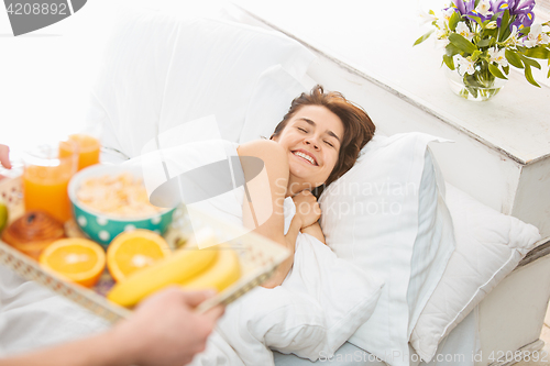 Image of Relaxed Couple in Bed in bedroom at home