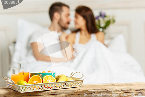 Image of Relaxed Couple in Bed in bedroom at home