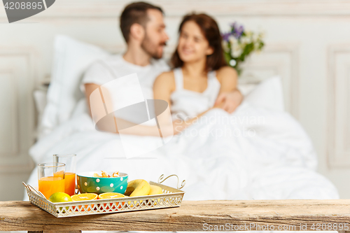 Image of Relaxed Couple in Bed in bedroom at home