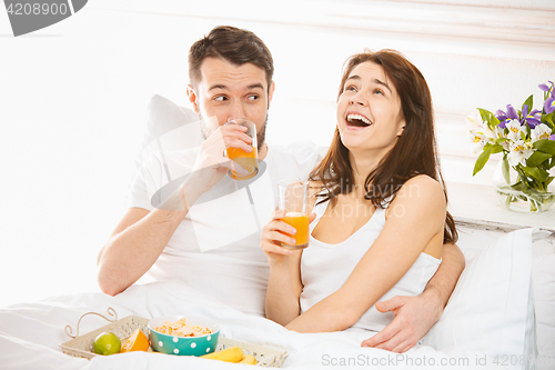 Image of Relaxed Couple in Bed in bedroom at home