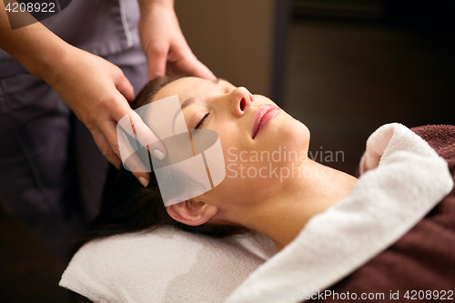 Image of woman having head massage at spa