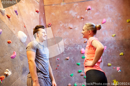 Image of man and woman talking at indoor climbing gym wall