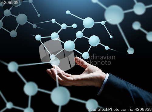 Image of close up of businessman hand with molecule