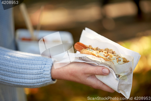 Image of close up of hand with hot dog