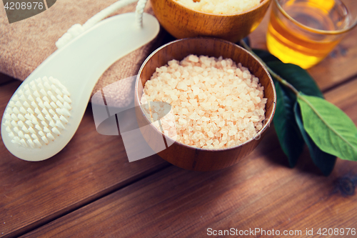 Image of close up of himalayan pink salt with brush on wood