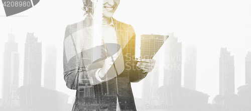 Image of businesswoman with clipboard over city buildings