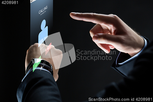 Image of close up of businessman hands with smartwatch