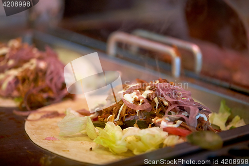 Image of tortilla wraps cooking at street market