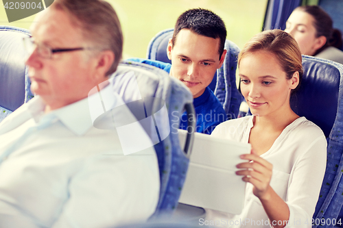 Image of happy couple with tablet pc in travel bus