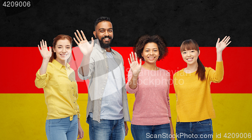 Image of international group of happy people waving hands