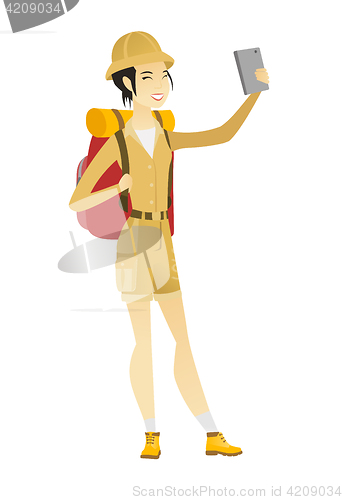 Image of Traveler woman with backpack making selfie.