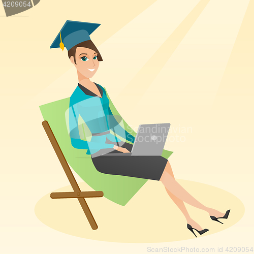 Image of Graduate lying in chaise lounge with laptop.