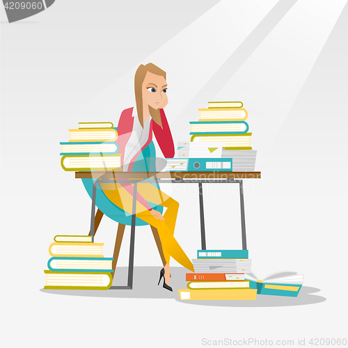 Image of Student sitting at the table with piles of books.