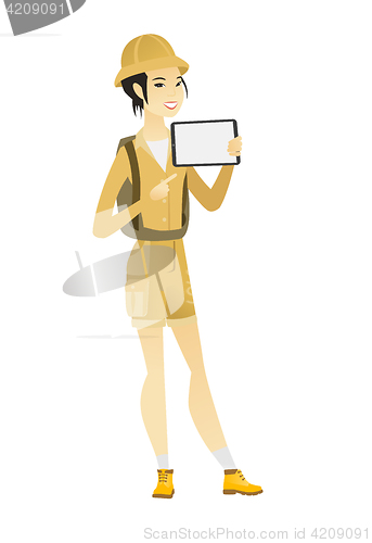 Image of Smiling traveler holding tablet computer.