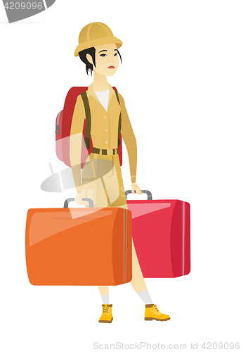 Image of Disappointed tourist holding two big suitcases.