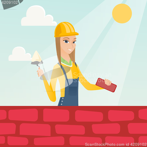 Image of Bricklayer working with spatula and brick.