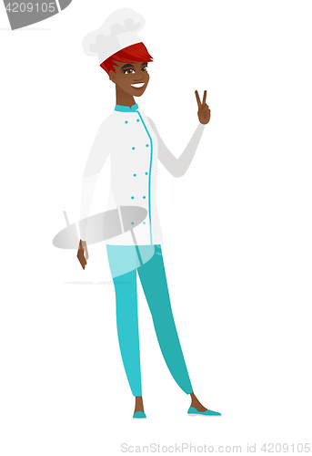Image of African-american chef cook showing victory gesture