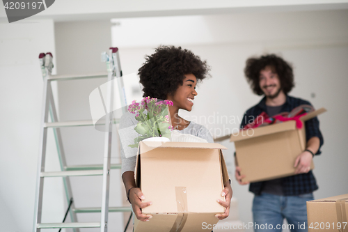 Image of multiethnic couple moving into a new home