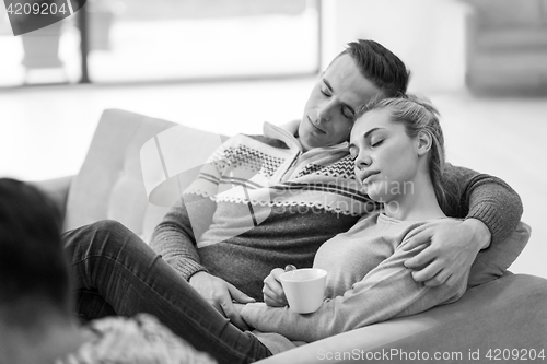 Image of Young couple  in front of fireplace