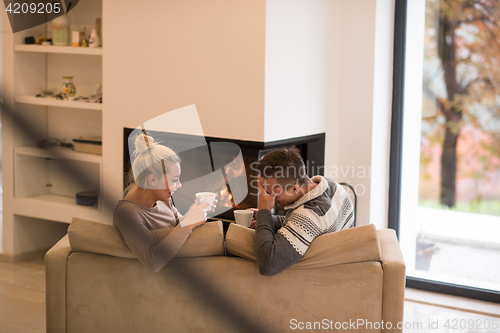 Image of Young couple  in front of fireplace