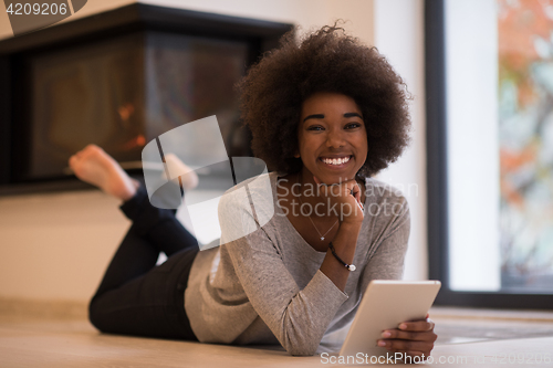 Image of black women using tablet computer on the floor