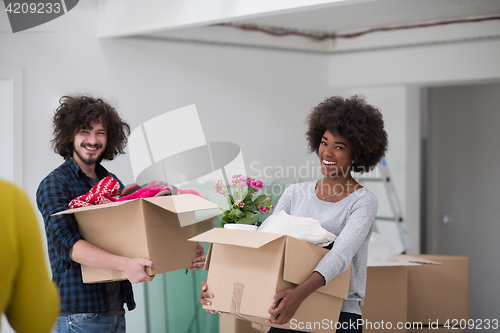 Image of multiethnic couple moving into a new home