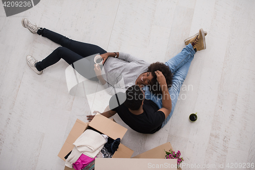 Image of African American couple relaxing in new house