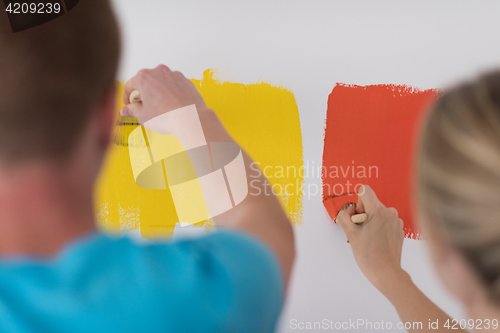 Image of couple painting interior wall