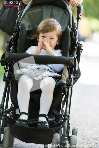 Image of mother pushed her baby daughter in a stroller