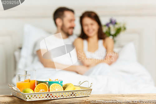 Image of Relaxed Couple in Bed in bedroom at home