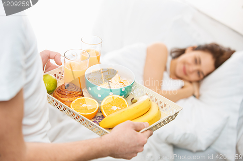 Image of Relaxed Couple in Bed in bedroom at home