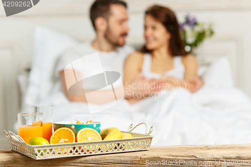 Image of Relaxed Couple in Bed in bedroom at home