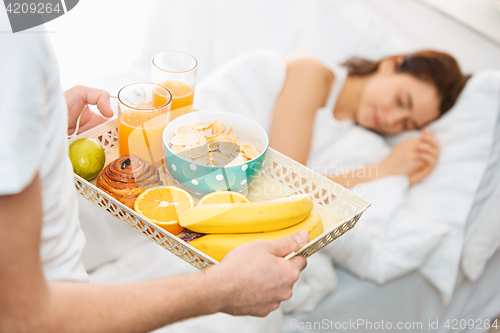 Image of Relaxed Couple in Bed in bedroom at home