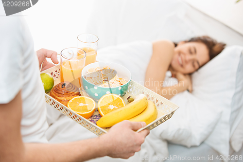 Image of Relaxed Couple in Bed in bedroom at home