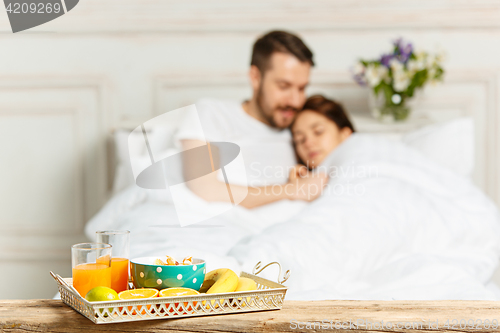 Image of Relaxed Couple in Bed in bedroom at home