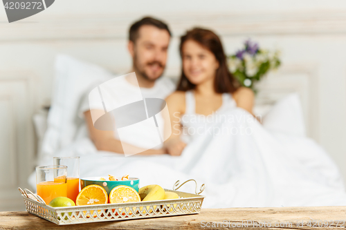 Image of Relaxed Couple in Bed in bedroom at home