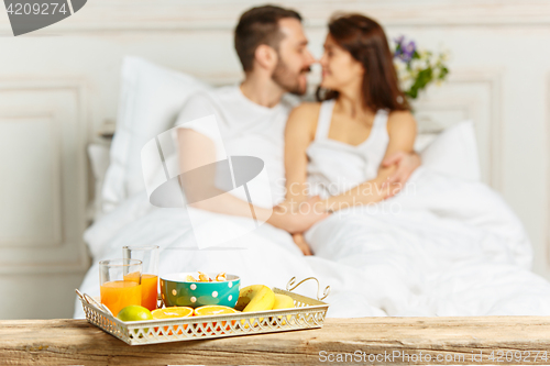 Image of Relaxed Couple in Bed in bedroom at home